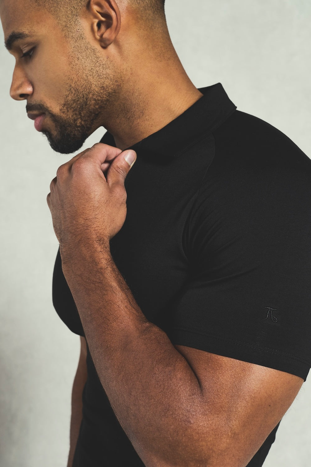 Essential Jersey Buttonless Polo Shirt in Black